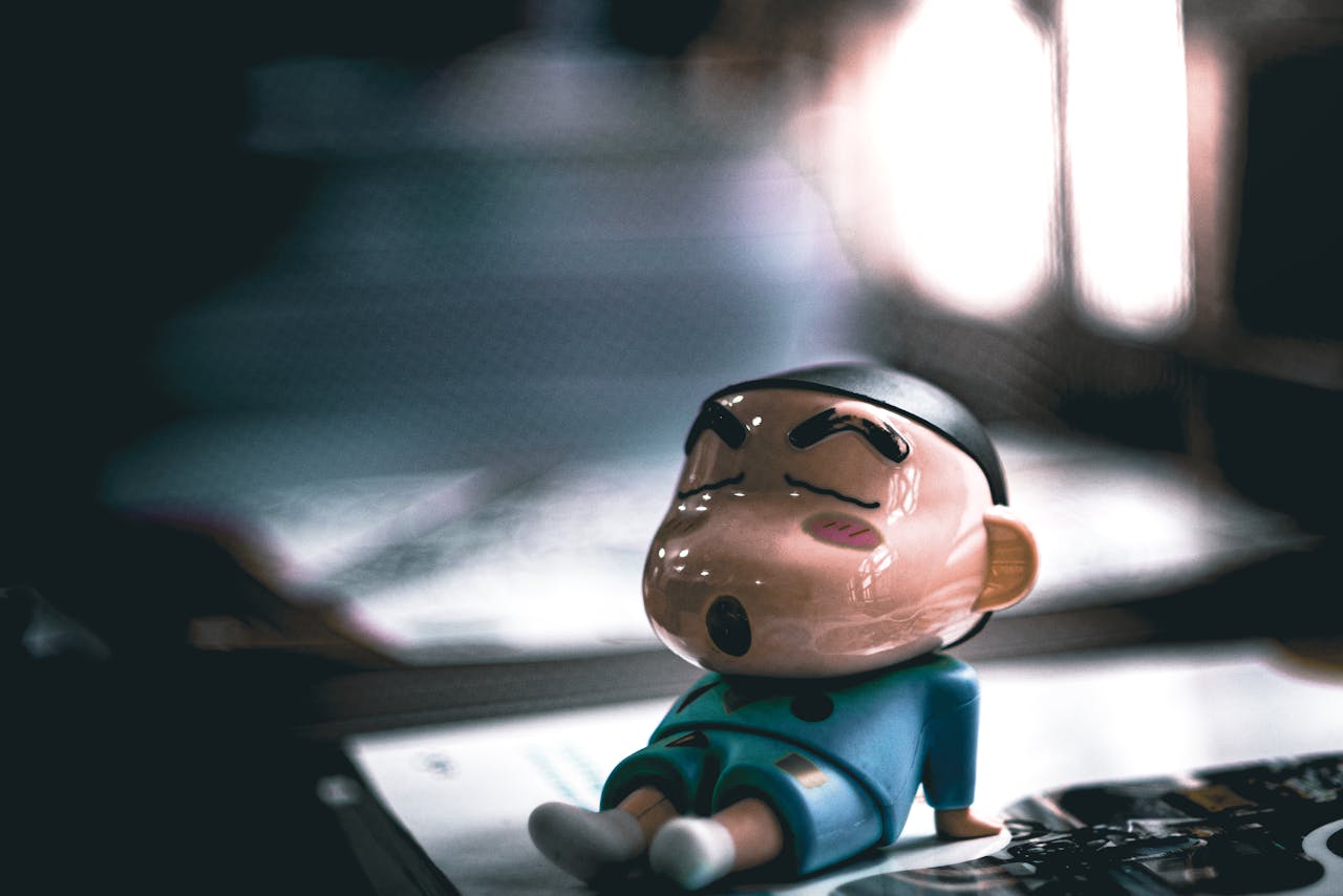 The Art of Drawing Readers In: Your attractive post title goes here Close-up of a cartoon figurine sleeping on a table with soft lighting.